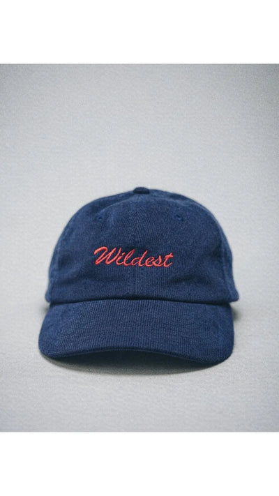 Corduroy navy blue baseball cap with red embroidery letters saying "wildest"