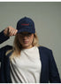 woman wearing navy blue corduroy baseball cap