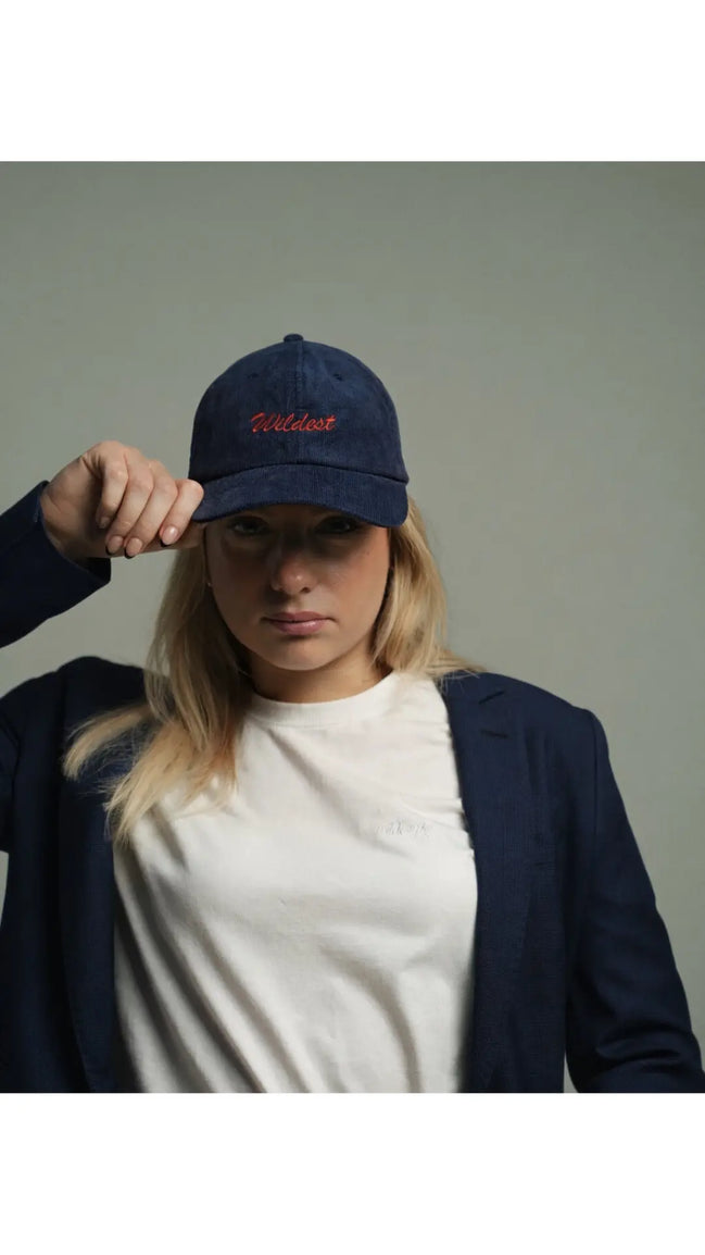 woman wearing navy blue corduroy baseball cap