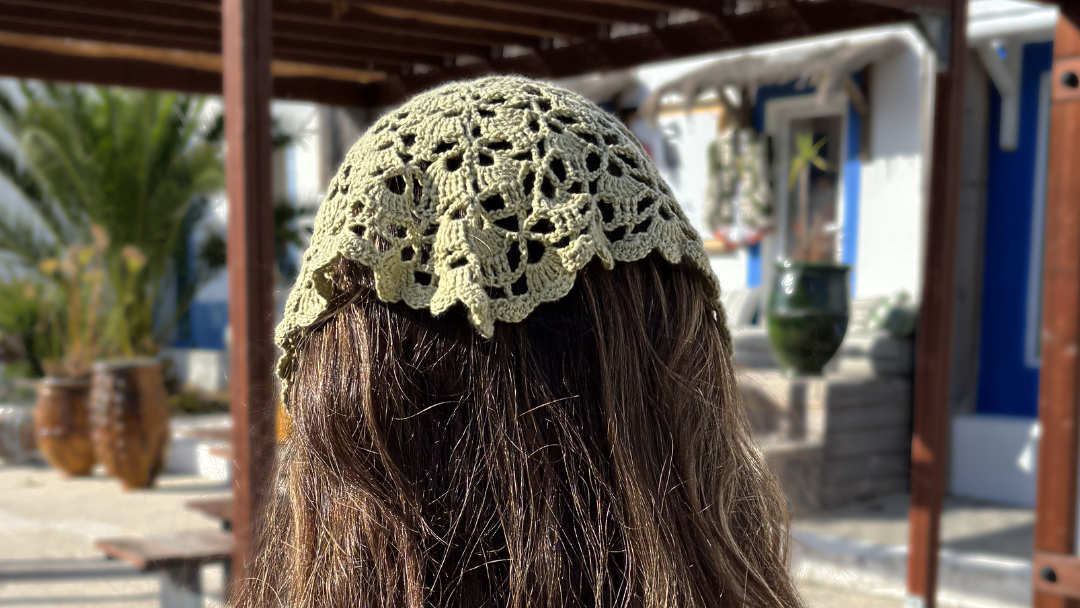 crochet sage green bandana on brunette  woman walking on the street in portugal for summer 2026 collection of the wildest fig