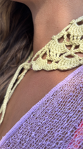 Close-up of a yellow crochet top with a blurred background for the wildest fig crochet collection f