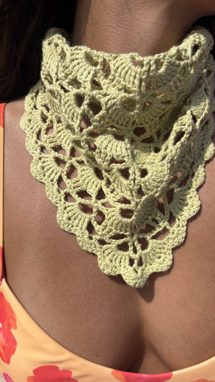 sage Green crochet shawl draped over a person wearing a floral bikini for summer 2026 the wildest fig crochet collection