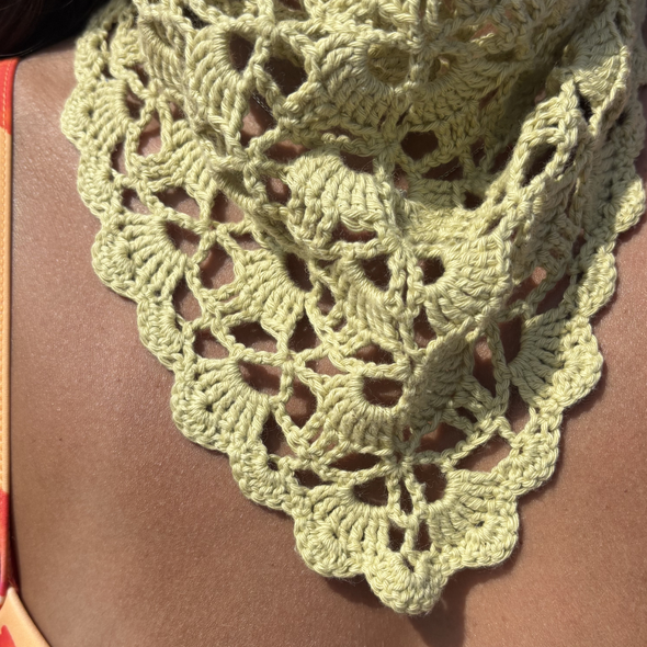 sage Green crochet shawl draped over a person wearing a floral bikini for summer 2026 the wildest fig crochet collection